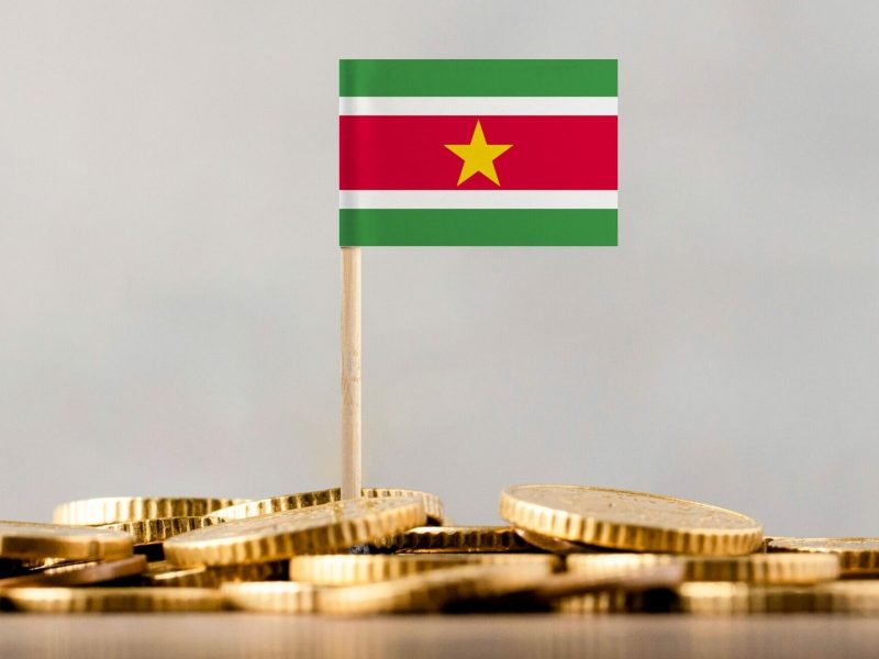 The,Flag,Of,Suriname,With,Coins.